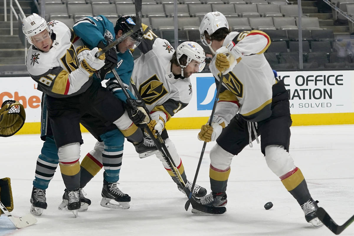 San Jose Sharks center Patrick Marleau, second from left, reaches for the puck between Vegas Go ...