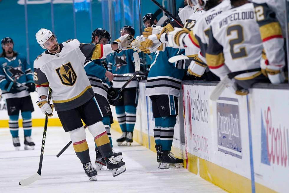 Vegas Golden Knights right wing Dylan Sikura, left, is congratulated by teammates after scoring ...