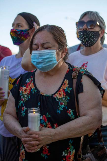 Maria Zapata prays during a vigil for 2-year-old Amari Nicholson, whose mother's boyfriend was ...