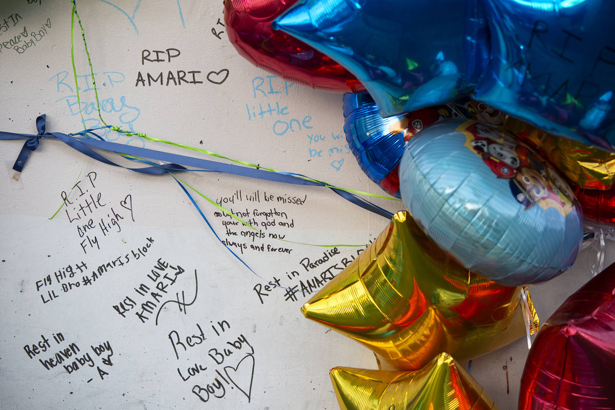 Mourners wrote notes on a pillar outside the Emerald Suites near where 2-year-old Amari Nichols ...
