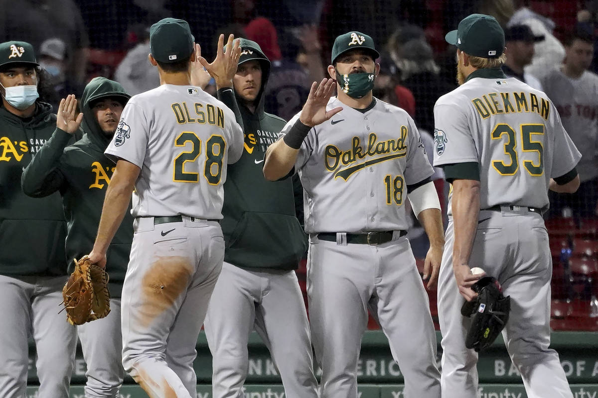 Oakland Athletics, including Mitch Moreland (18), congratulate each other after a 3-2 win over ...