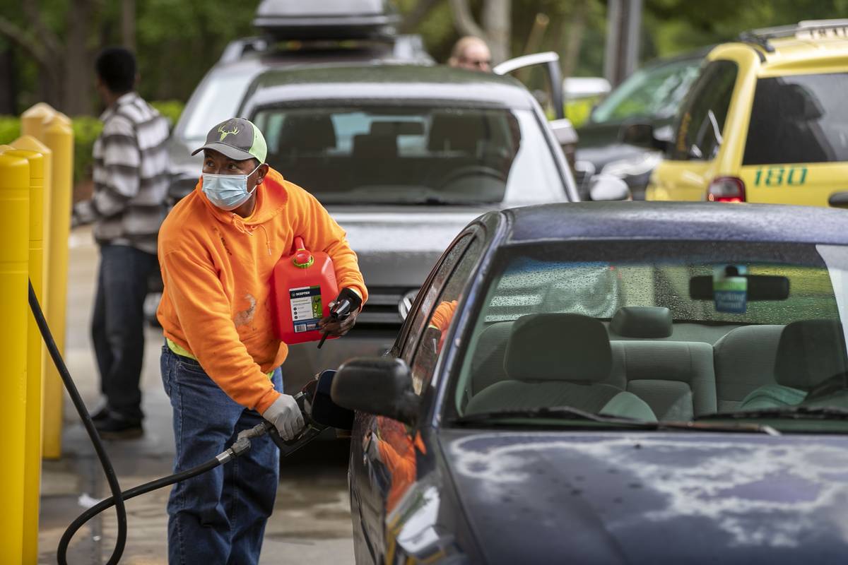 Customers fill up their automobiles and gas containers with fuel at the Circle K on Wednesday, ...