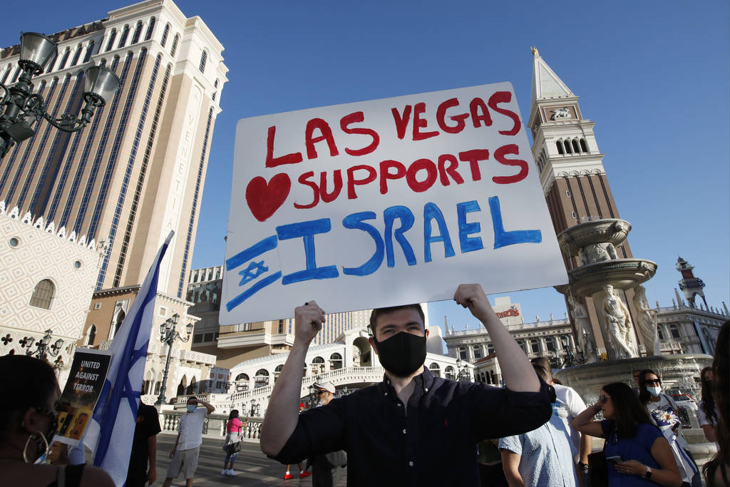 Michael Scheinman of Las Vegas holds a sign during a rally in support of Israel outside The Ven ...