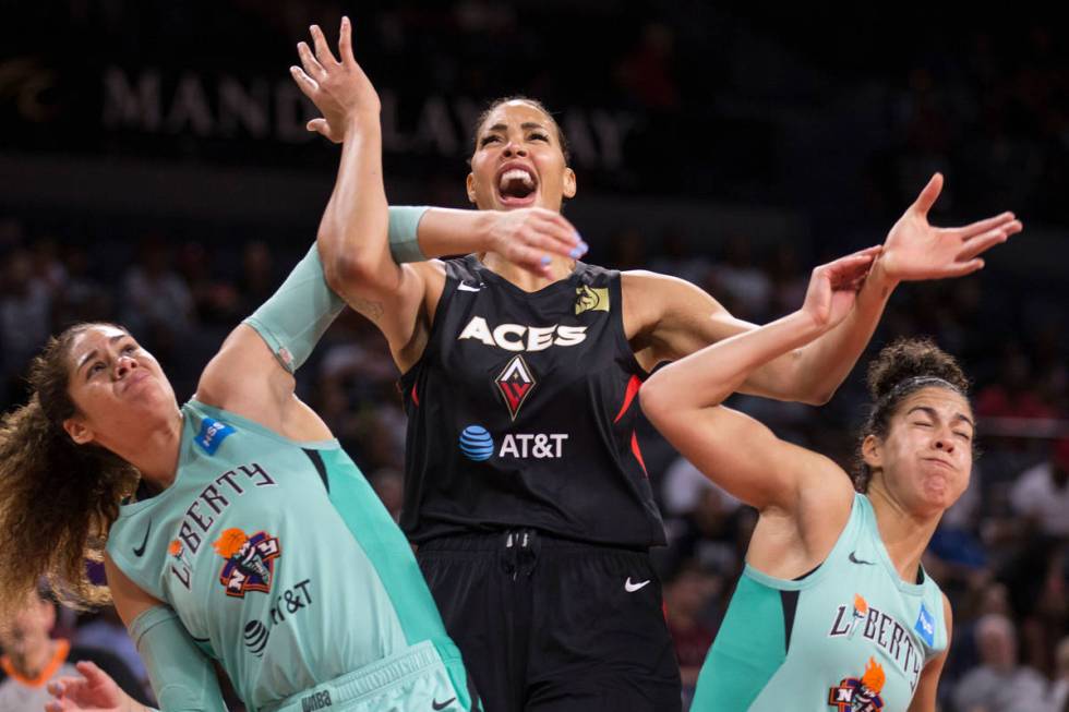 Las Vegas Aces center Liz Cambage (8) fights for position with New York Liberty center Amanda Z ...