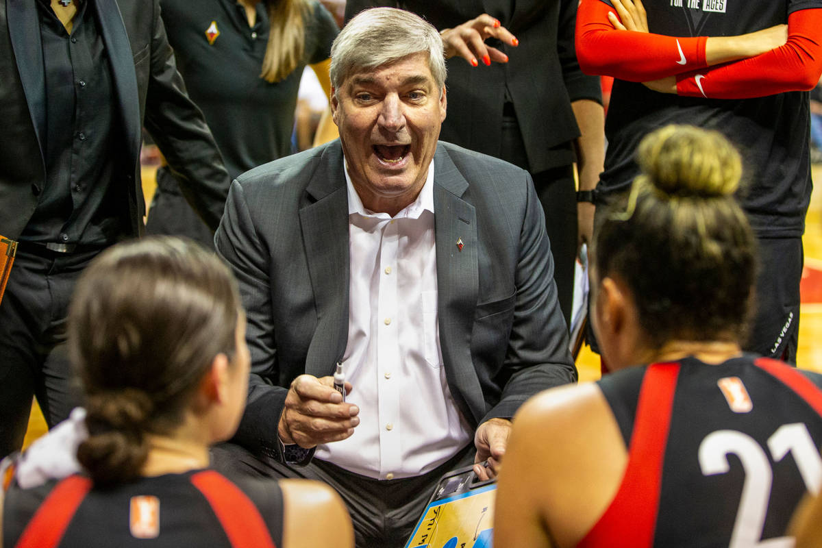 Las Vegas Aces head coach Bill Laimbeer talks up his players in a huddle during a timeout as th ...