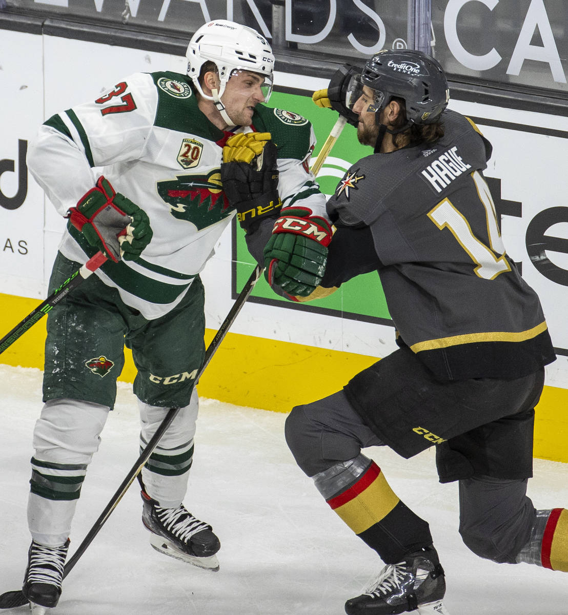 Minnesota Wild center Kyle Rau (37) takes a shot to the chin from Golden Knights defenseman Nic ...
