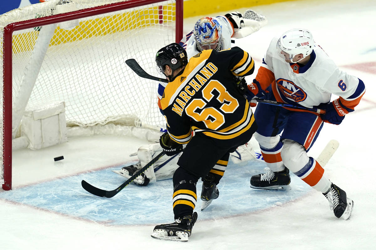 Boston Bruins center Brad Marchand (63) scores past New York Islanders goaltender Semyon Varlam ...