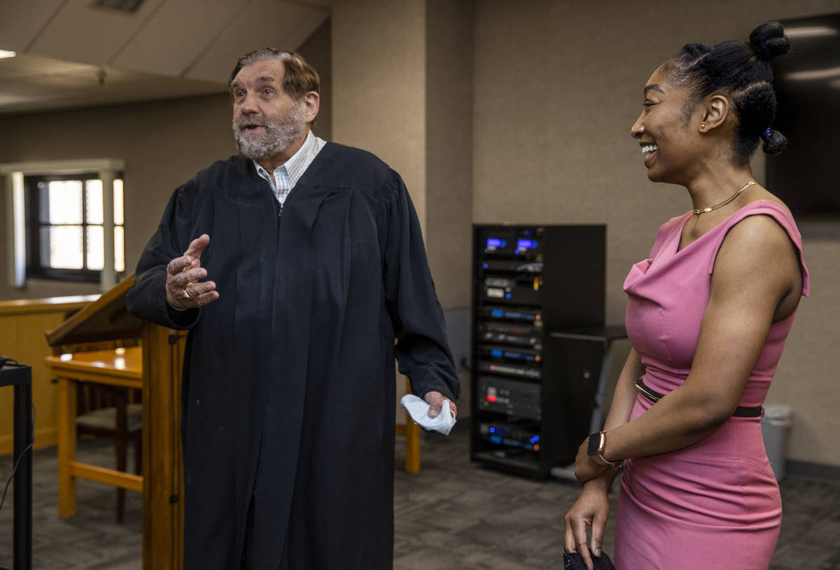 Justice Michael Cherry, left, talks about his days in law school prior to a swearing in ceremon ...