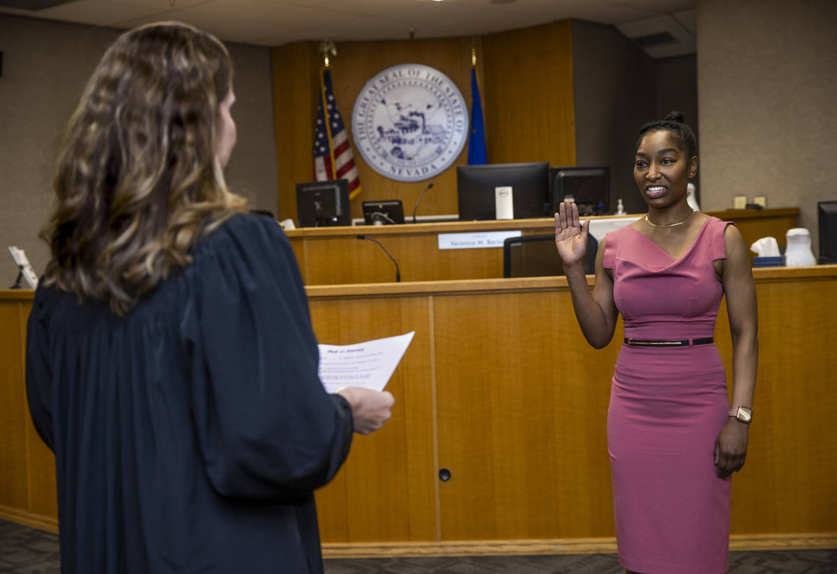 Dominique Bosa-Edwards, right, a former District Court marshal, is sworn in by Judge Veronica M ...
