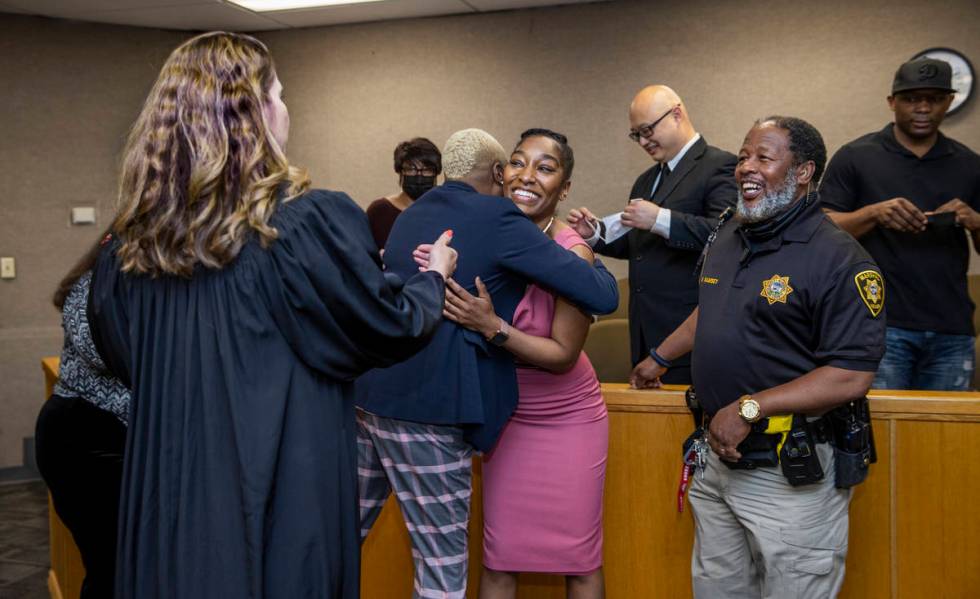 Dominique Bosa-Edwards, center, a former District Court marshal, who passed the Nevada State Ba ...