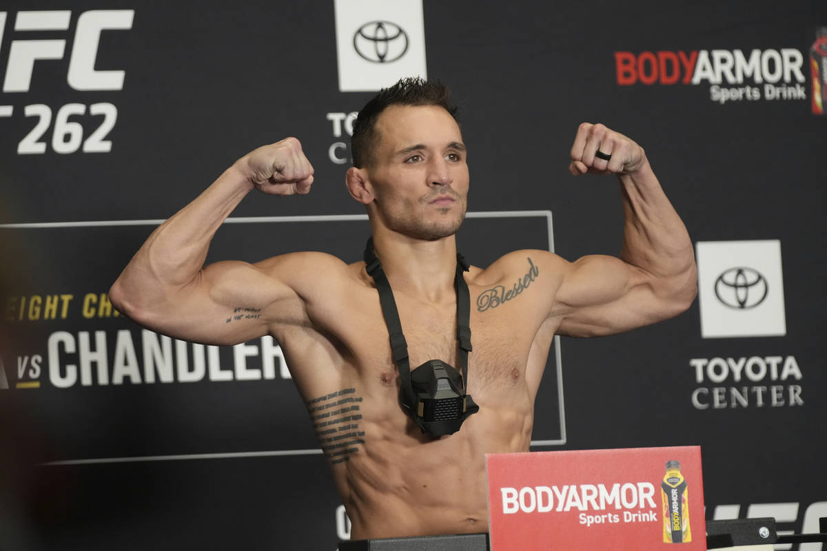 Michael Chandler jumps on the scale for the UFC 262 Official Weigh-in on May 14, 2021, at Marri ...