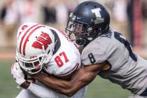 In this Oct.19, 2019, file photo, Illinois defender Nate Hobbs (8) takes down Wisconsin's Quint ...