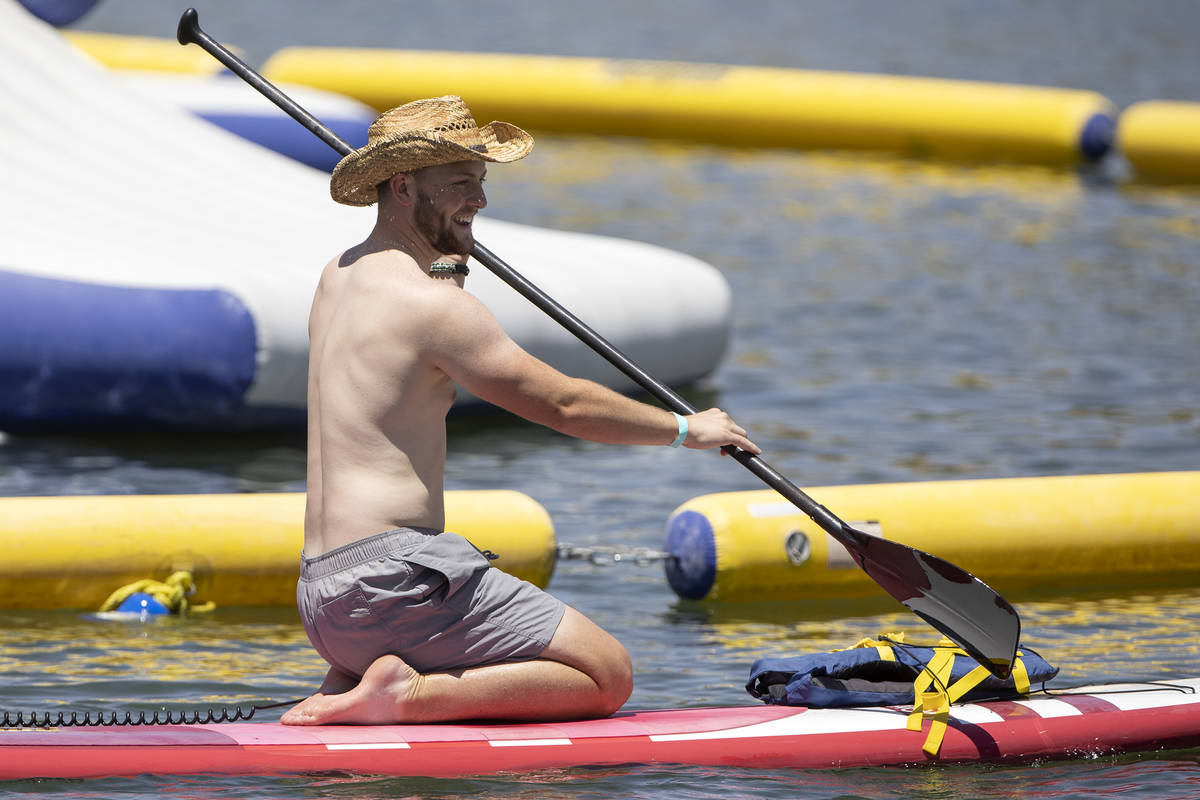 A paddle boarder makes his way out on the water at Lake Las Vegas on Saturday, May 15, 2021 in ...