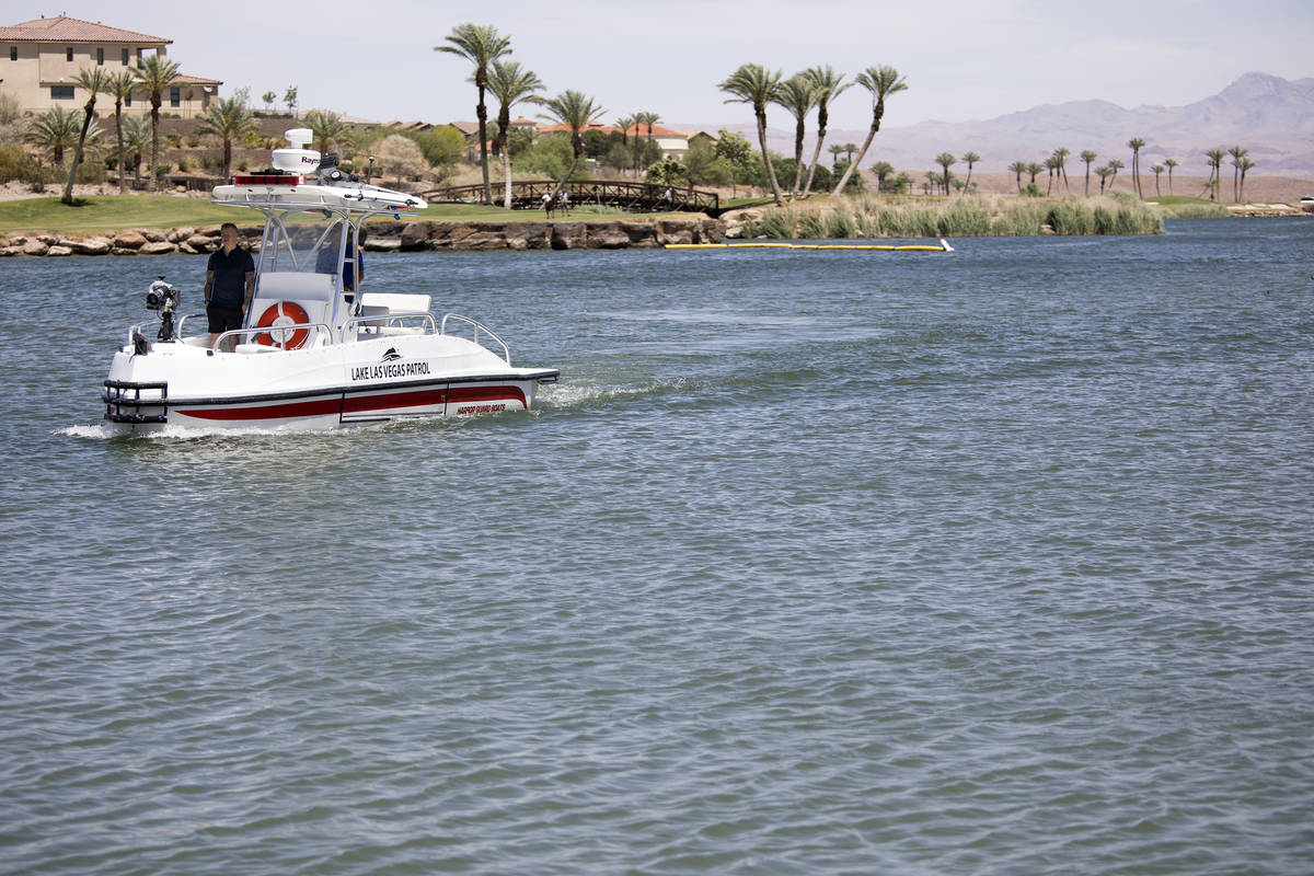 High winds ripple the water as Lake Las Vegas Patrol drives around the water at Lake Las Vegas ...