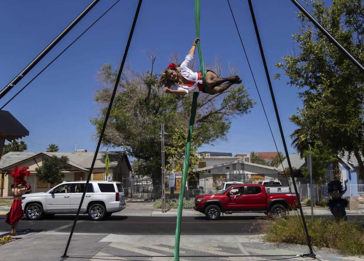 Aerial silks artist Leisha Knight performs for passing cars during the Las Vegas Days Parade on ...