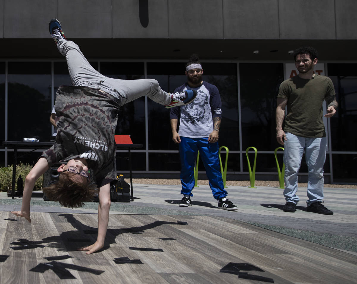Roves Carreira, left, with Alchemy Breaking Academy, performs on the sidewalk during the Las Ve ...