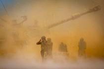 An Israeli artillery unit fires toward targets in Gaza Strip, at the Israeli Gaza border, Wedne ...