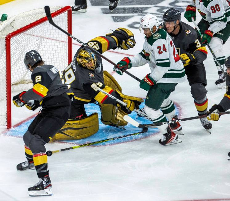 Golden Knights goaltender Marc-Andre Fleury (29) defends the net as Minnesota Wild defenseman M ...