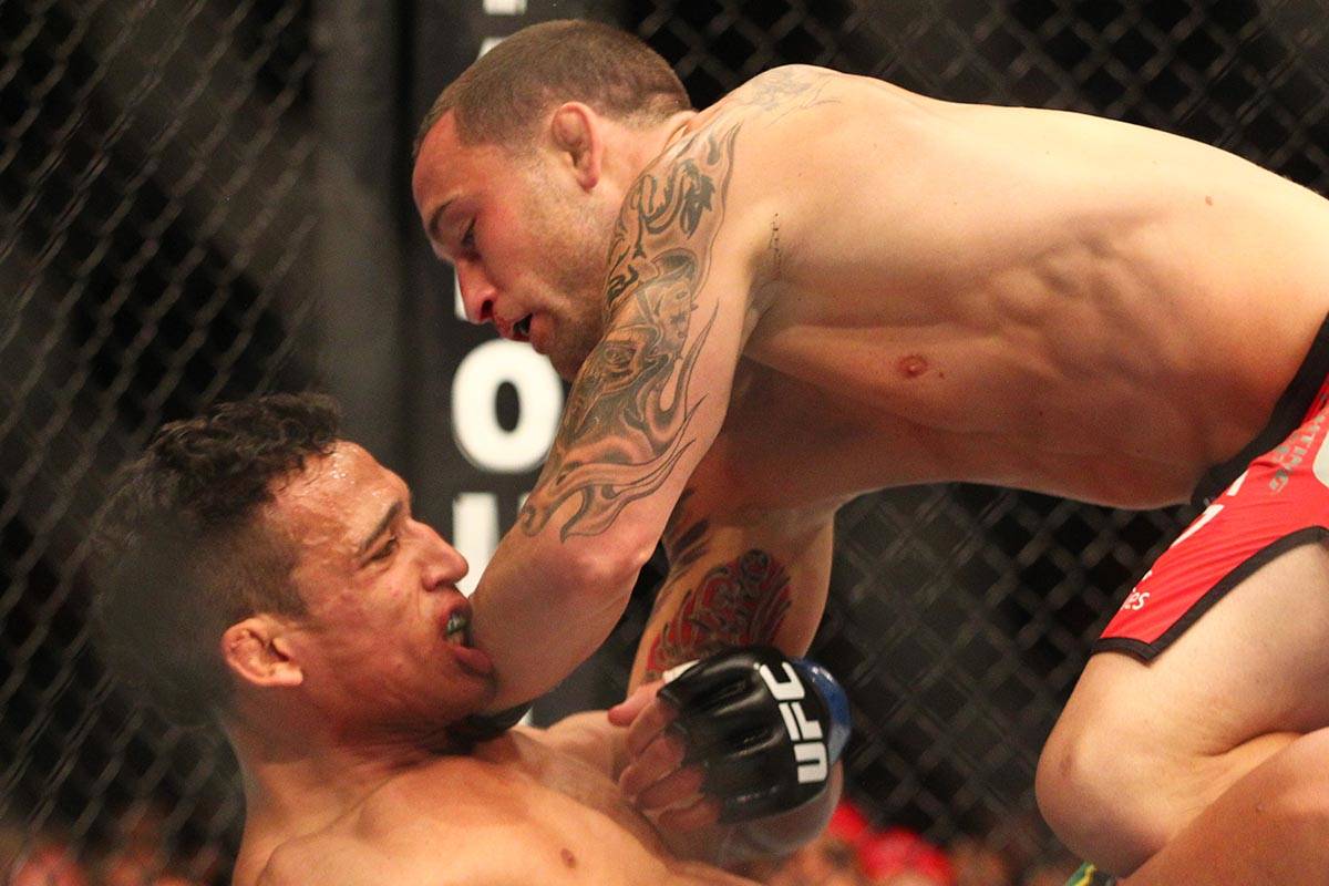 Frankie Edgar brings down Charles Oliveira in a featherweight bout during UFC 162 at the MGM Gr ...