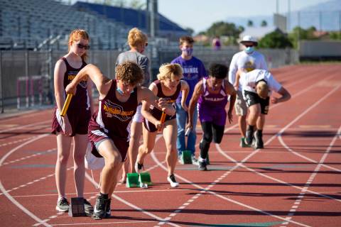 High school track and field athletes compete in the 4x400-meter race during a meet at Durango H ...