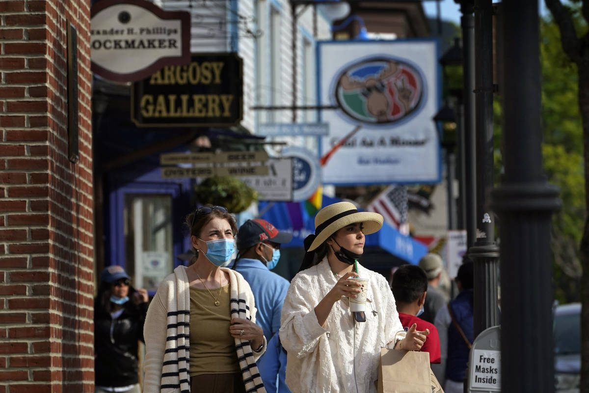 Visitors walk on a busy sidewalk, Saturday, May 15, 2021, in Bar Harbor, Maine. Gov. Janet Mill ...