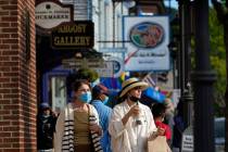 Visitors walk on a busy sidewalk, Saturday, May 15, 2021, in Bar Harbor, Maine. Gov. Janet Mill ...