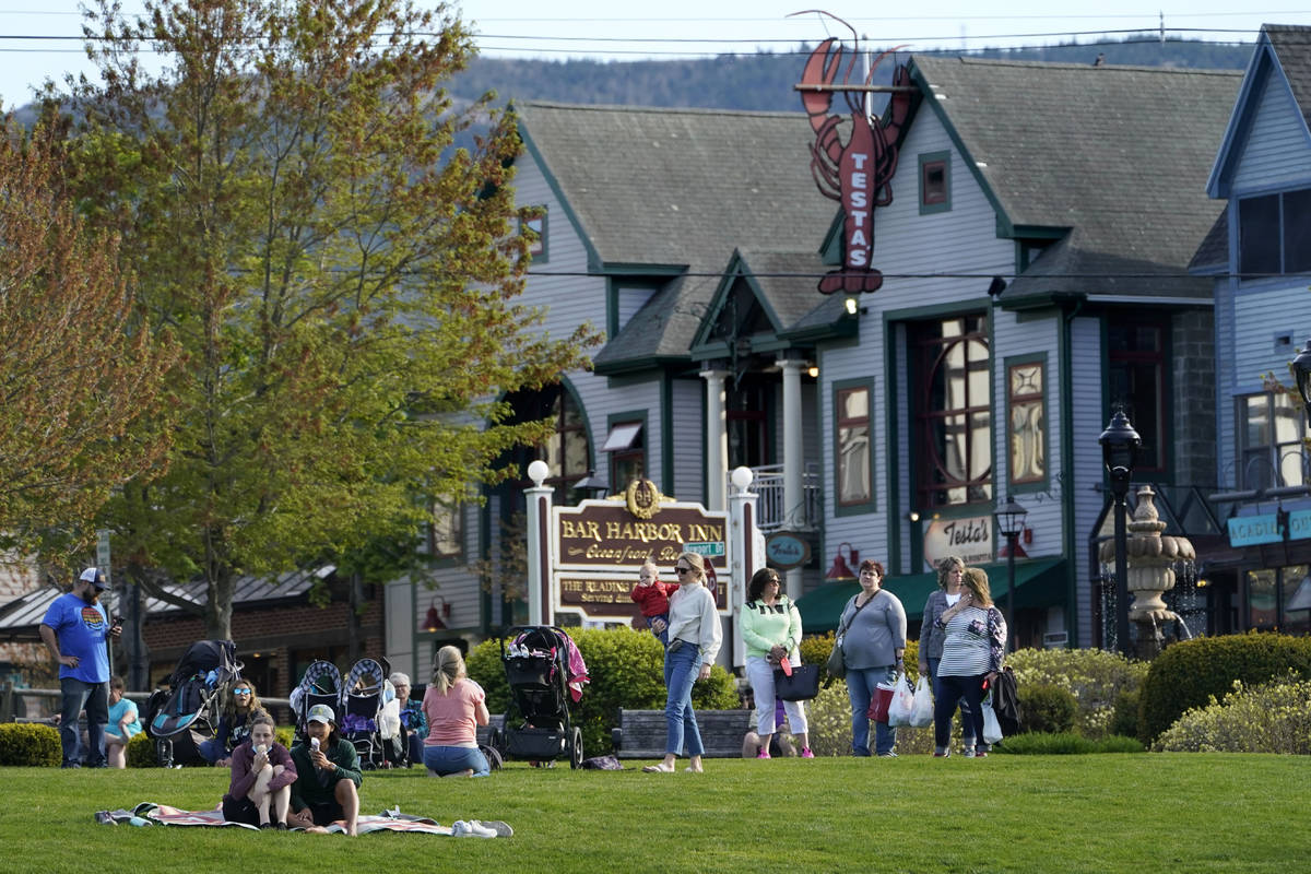 Visitors gather at a waterfront park, Saturday, May 15, 2021, in Bar Harbor, Maine. Gov. Janet ...