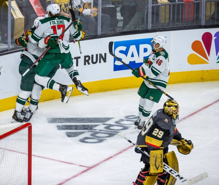 Minnesota Wild players celebrate their winning goal as Golden Knights goaltender Marc-Andre Fle ...