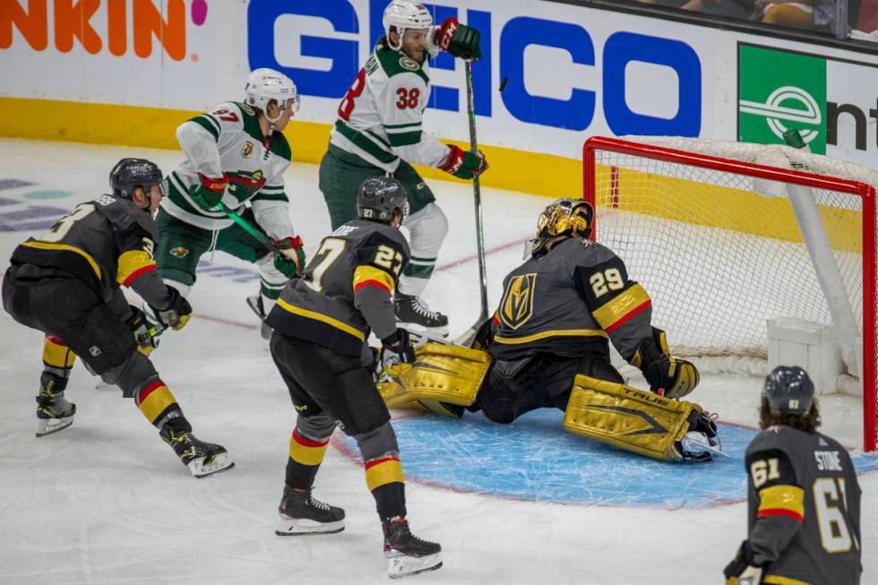 Golden Knights goaltender Marc-Andre Fleury (29) deflects a shot off his chest as Minnesota Wil ...