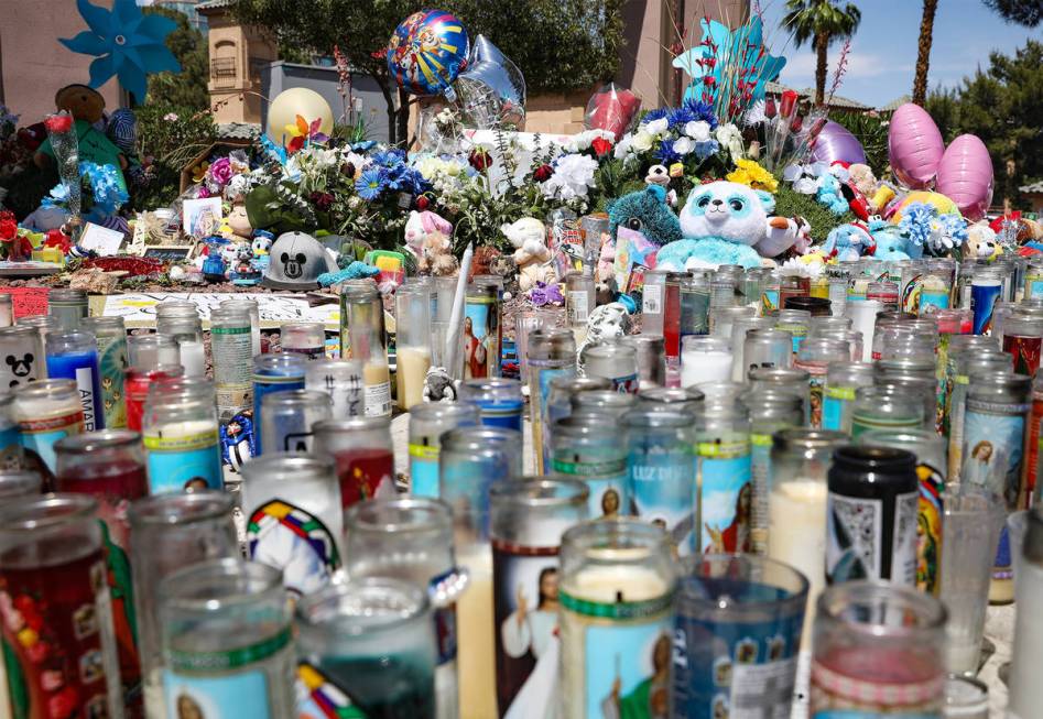 Candles and trinkets for 2-year-old Amari Nicholson, who was killed earlier in the month, near ...