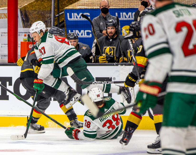 Minnesota Wild left wing Kirill Kaprizov (97) leaps over teammate right wing Ryan Hartman (38) ...