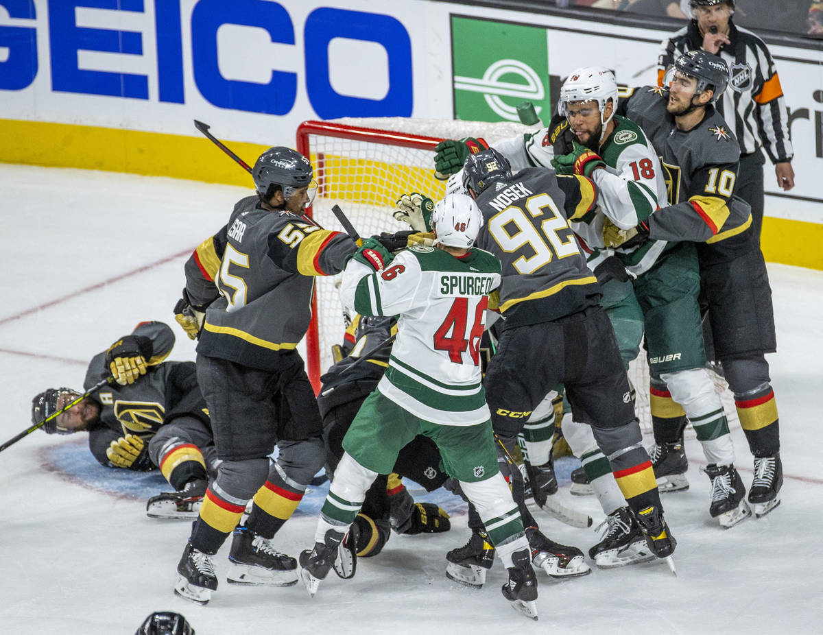 Golden Knights and Minnesota Wild players fight during the third period of an NHL playoff game ...