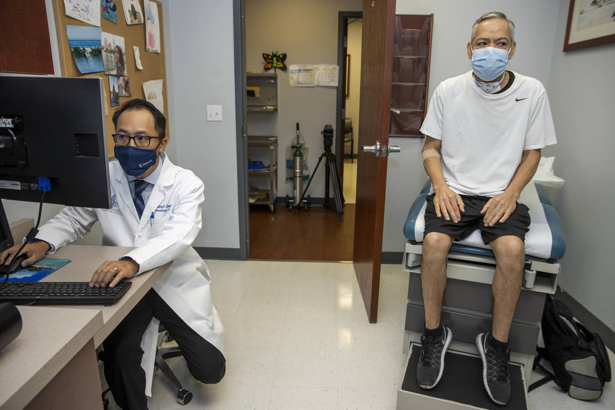 Patient Ruben Solis, right, sits as his Dr. Anthony Nguyen goes over his notes at the Comprehen ...