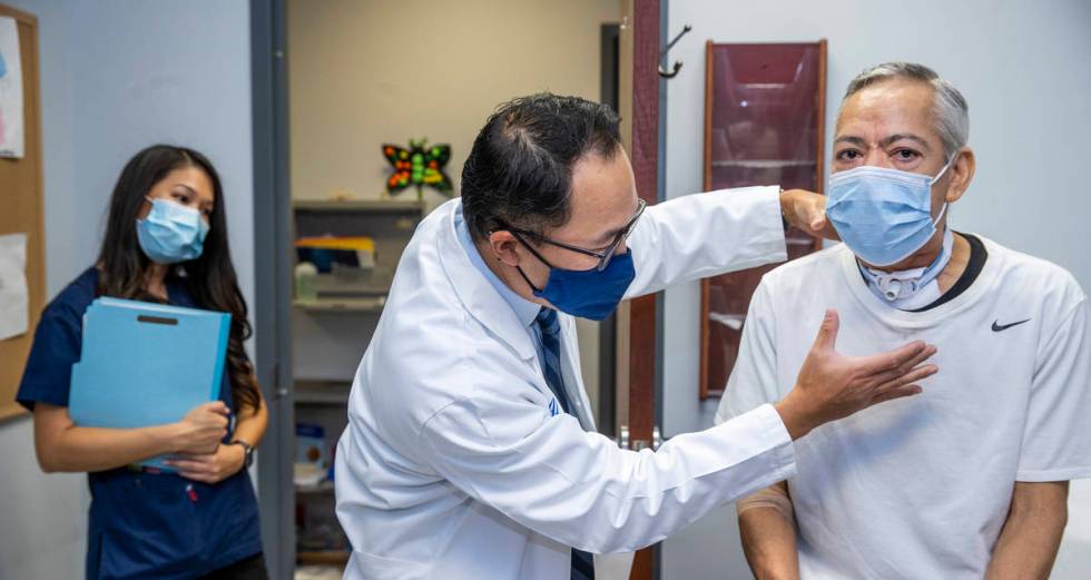 Patient Ruben Solis, right, is examined by Dr. Anthony Nguyen at the Comprehensive Cancer Cente ...