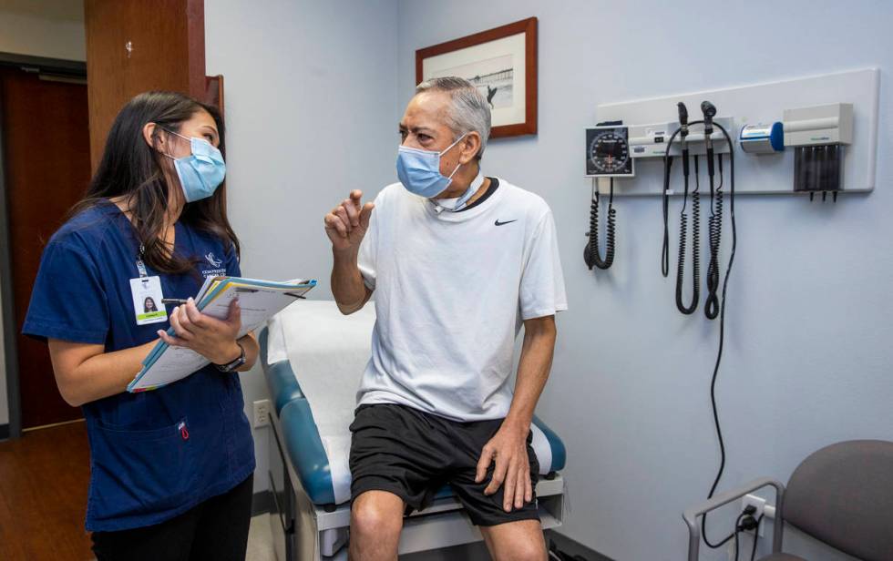 Clinical Research Coordinator Lindsay Kondo, left, checks the current physical status of patien ...