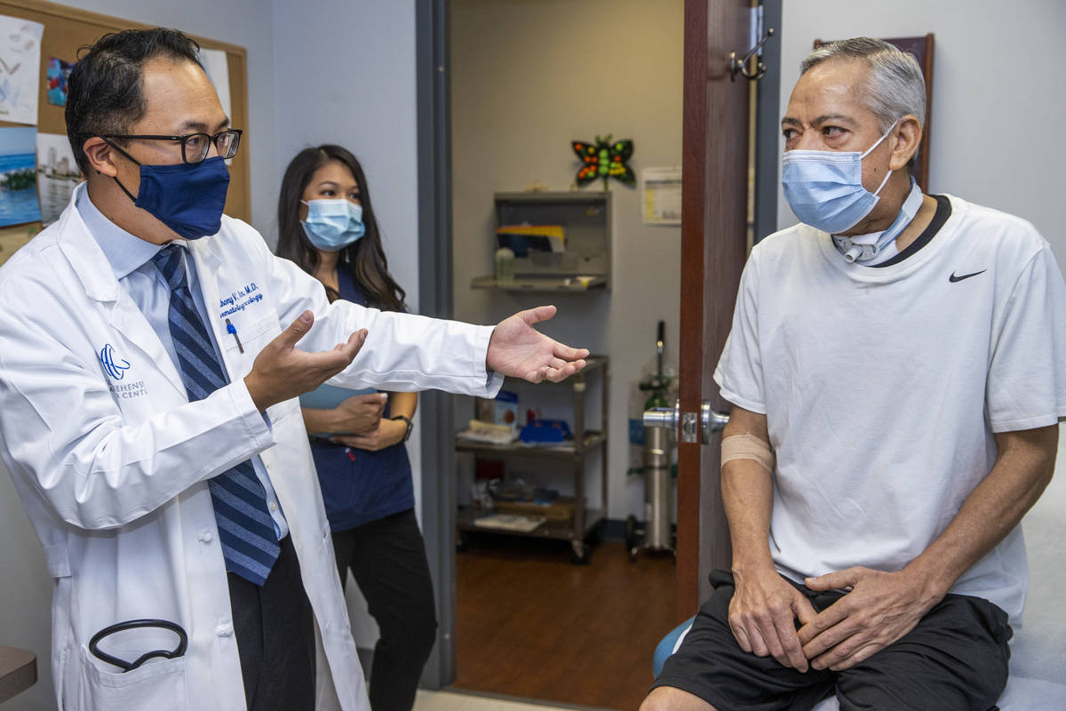 Dr. Anthony Nguyen, left, speaks to patient Ruben Solis at the Comprehensive Cancer Centers' So ...