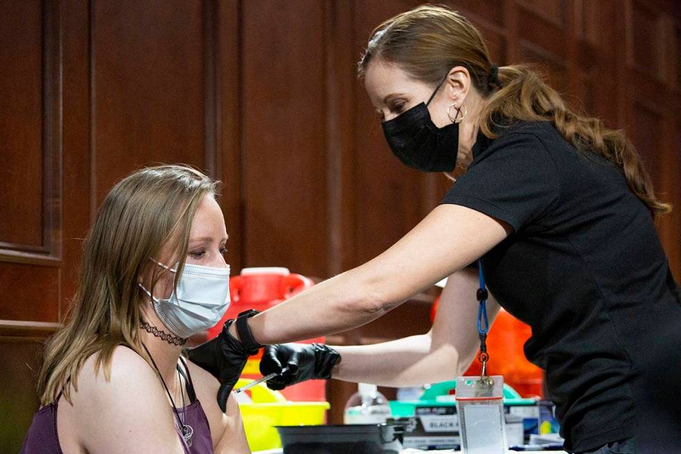 Savannah Wilkinson receives the Pfizer vaccine from Sarah Lugo, senior community health nurse w ...