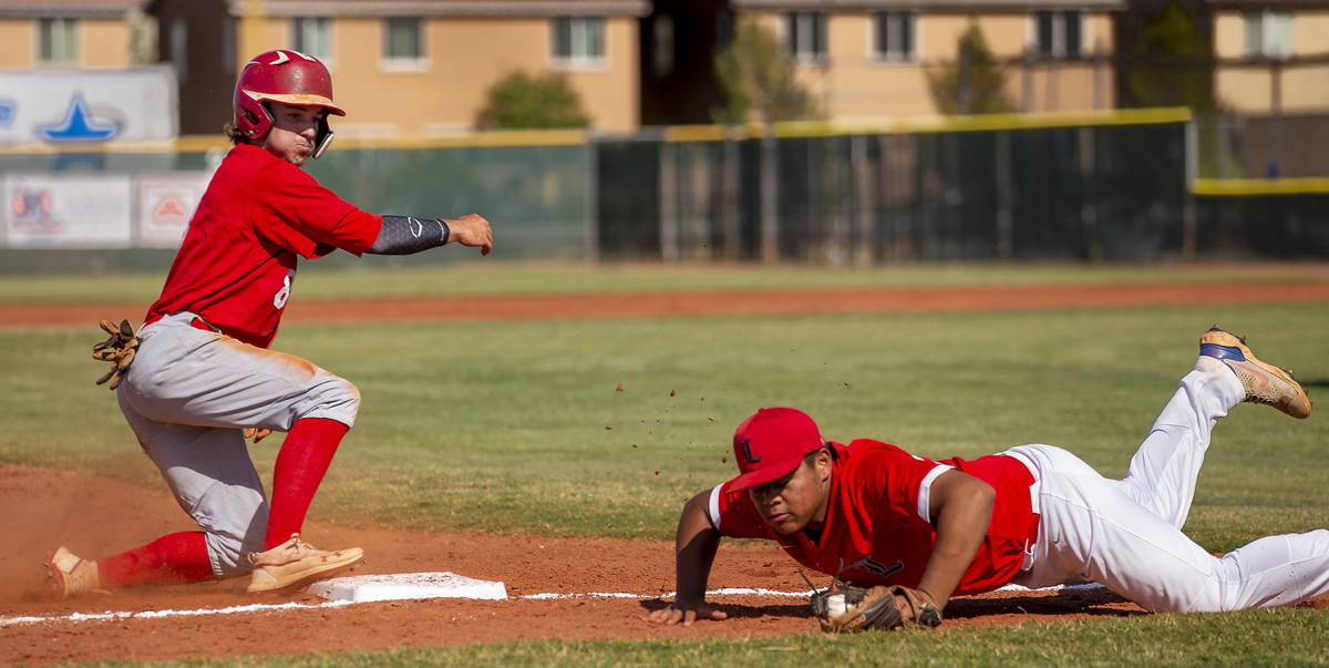 Arbor View runner Seth Parr (8) makes it to third base safely as Liberty infielder Keoni Young ...