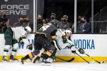 Wild left wing Jordan Greenway (18) dives for the puck followed by Golden Knights defenseman Ni ...