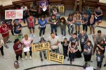 In this March 30, 2021, file photo, pro-life demonstrators gather in the rotunda at the Capitol ...