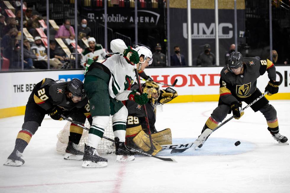 Golden Knights defenseman Zach Whitecloud (2) defends while goaltender Marc-Andre Fleury (29) s ...