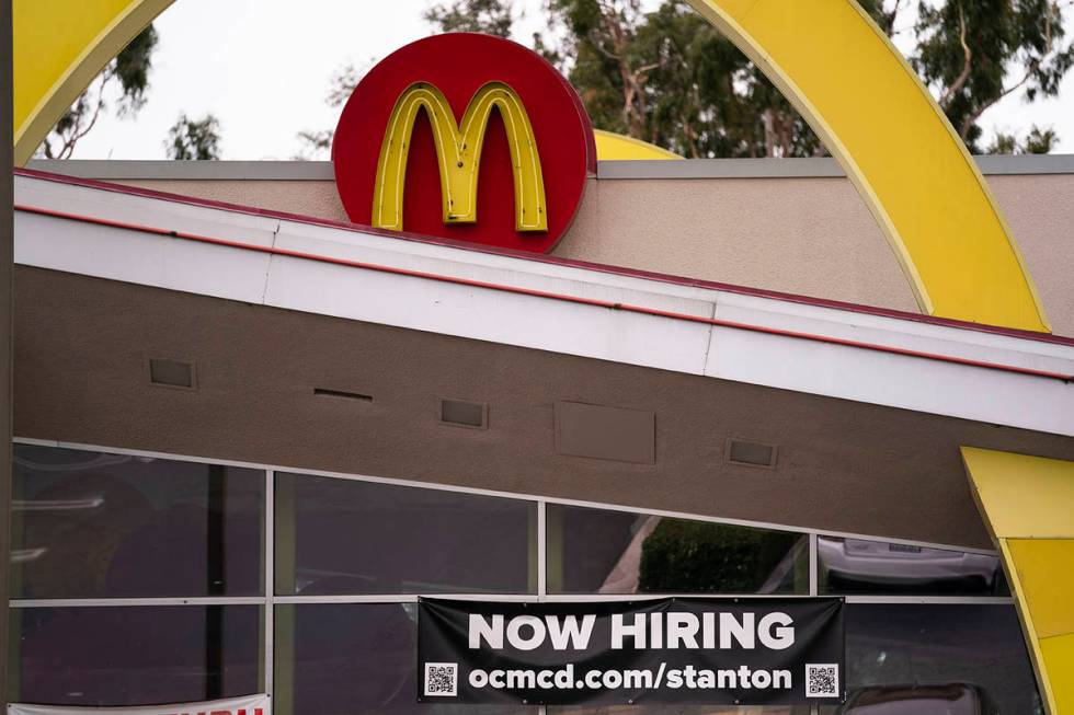A hiring banner hangs outside a McDonald's fast-food restaurant in Stanton, Calif., Monday, May ...