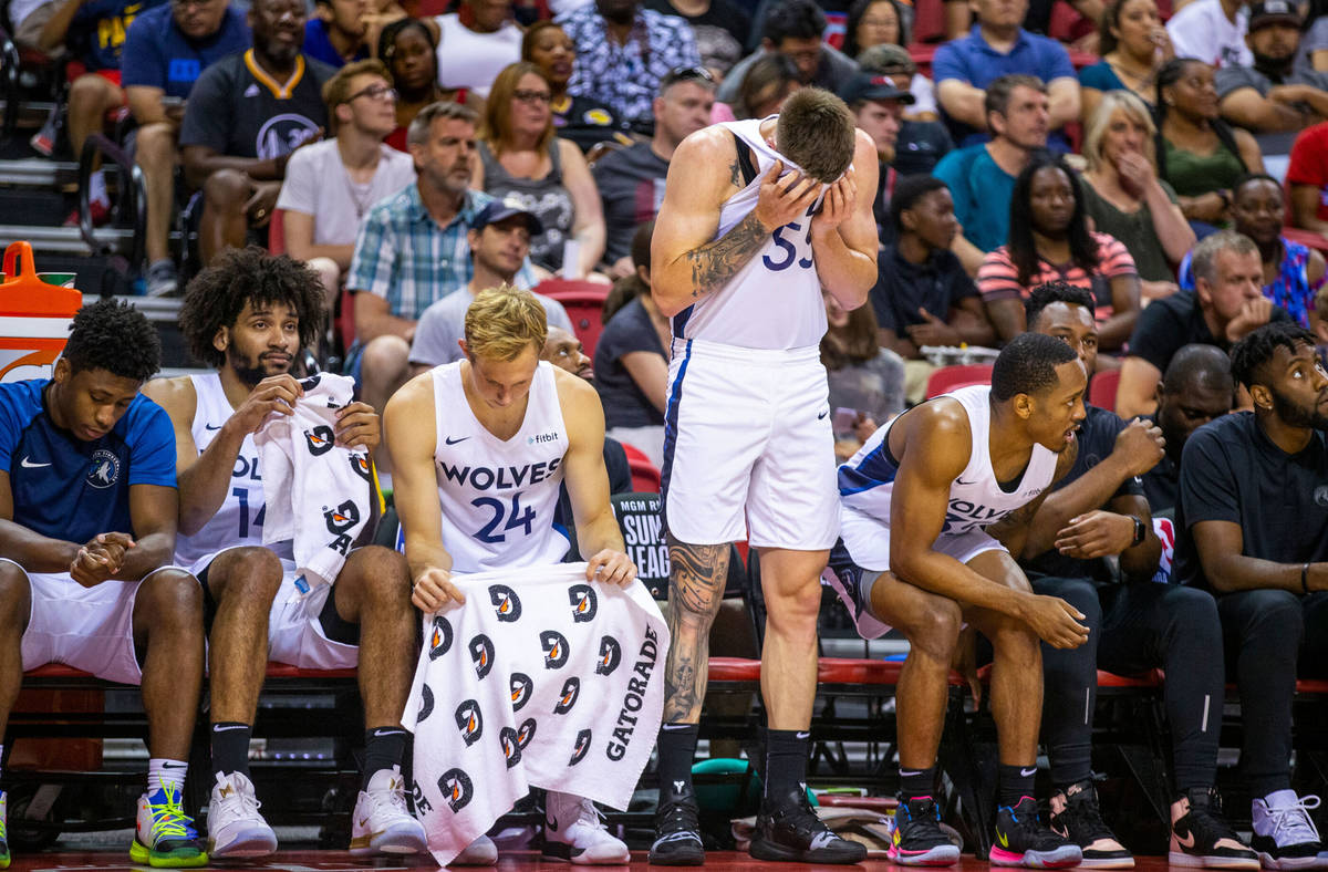 Minnesota Timberwolves forward Mitchell Creek wipes his eyes while standing beside his teammate ...
