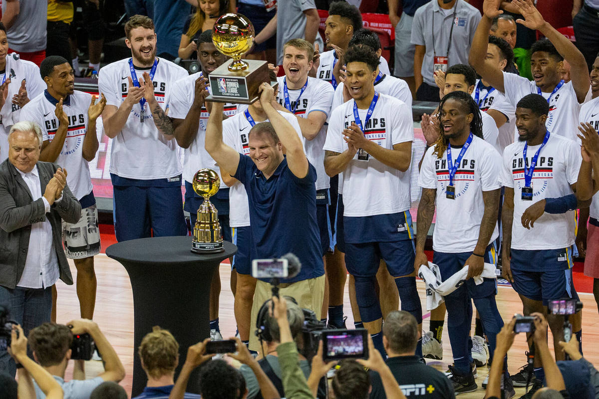 Memphis Grizzlies head coach Taylor Jenkins hoists the winning trophy after his team defeated t ...