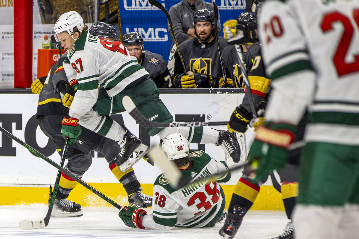 Minnesota Wild left wing Kirill Kaprizov (97) leaps over teammate right wing Ryan Hartman (38) ...