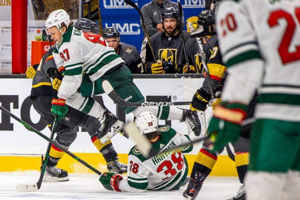 Minnesota Wild left wing Kirill Kaprizov (97) leaps over teammate right wing Ryan Hartman (38) ...