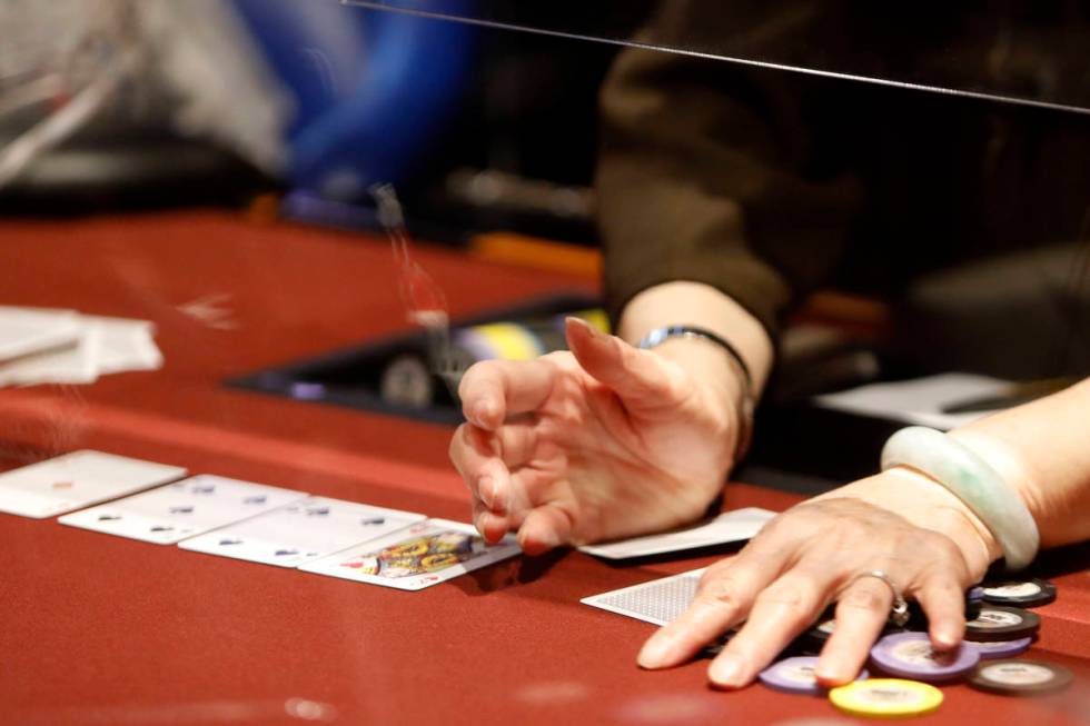 A dealer handles chips in $175 No-Limit Hold'em Ladies tournament during 2021 Nevada State Ladi ...