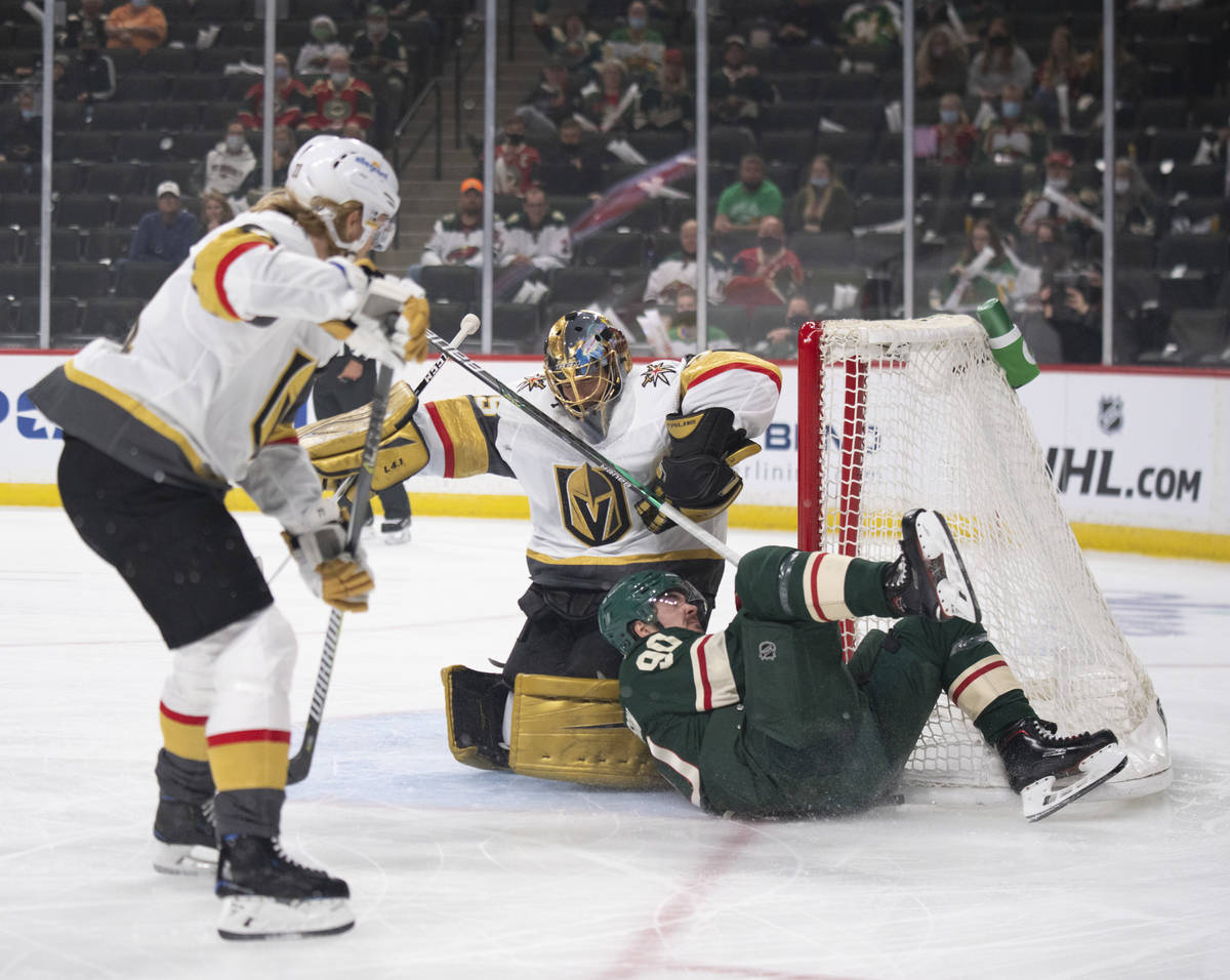 Minnesota Wild center Marcus Johansson (90) crashes against the net and Vegas Golden Knights go ...