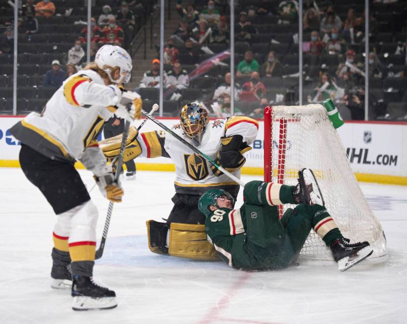 Minnesota Wild center Marcus Johansson (90) crashes against the net and Vegas Golden Knights go ...