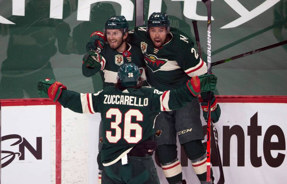 Minnesota Wild's Ryan Hartman (38) celebrates with teammates Matt Dumba (24) and Mats Zuccarell ...